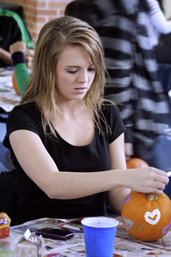 Senior Haley Warner has participated in the Pumpkin Painting Party since her sophomore year. She went because it sounded fun and her friends were going. Photo by Racheal Koole.