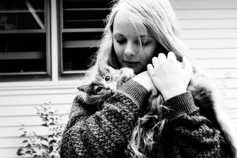 Iris Tanja hugs a kitten named Ramona. Tanja is an avid reader, as well as a serial cat cuddler. 
Photo Credit: Jazz Porter
