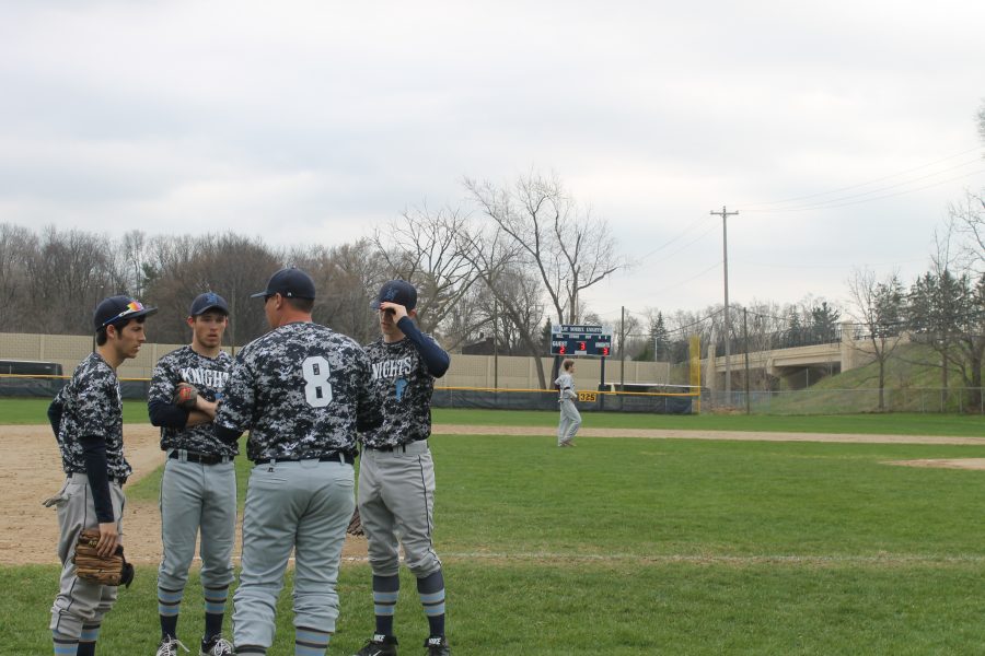 Coach Neel talks the last inning over with the outfielders. Photo Credit / Aj Rogers