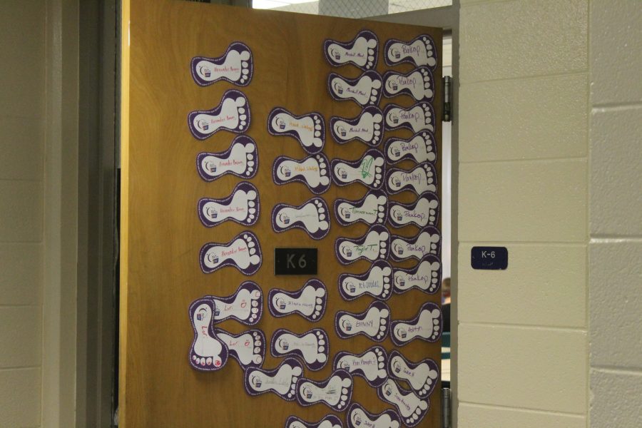 The door to Ms. Pankop's room is covered in feet, representing each of the students from her class who have donated to Relay for Life.