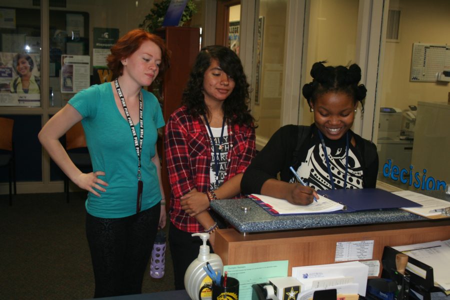 Shukrani Nsenga, Stephanie Gonzalez, and Arya Malmgren sign up for on-site admissions. It is an exciting yet stressful time of year for these students.
Photo Credit / Caitlin Commissaris
