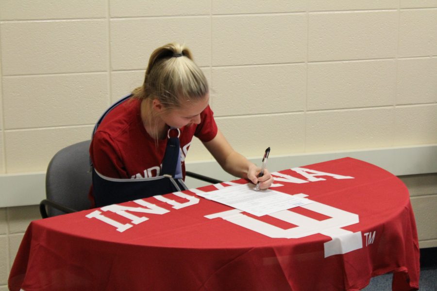 Grace Labadie signs her four year commitment to Indiana. She has played varsity soccer for the Knights since freshman year. Photo Credit / Chris Hybels
