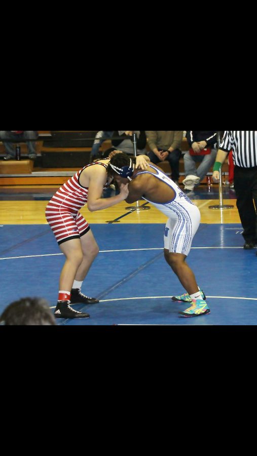Jalen Pace wrestling to be the conference champion. Photo credit / Marelyn Krueger 