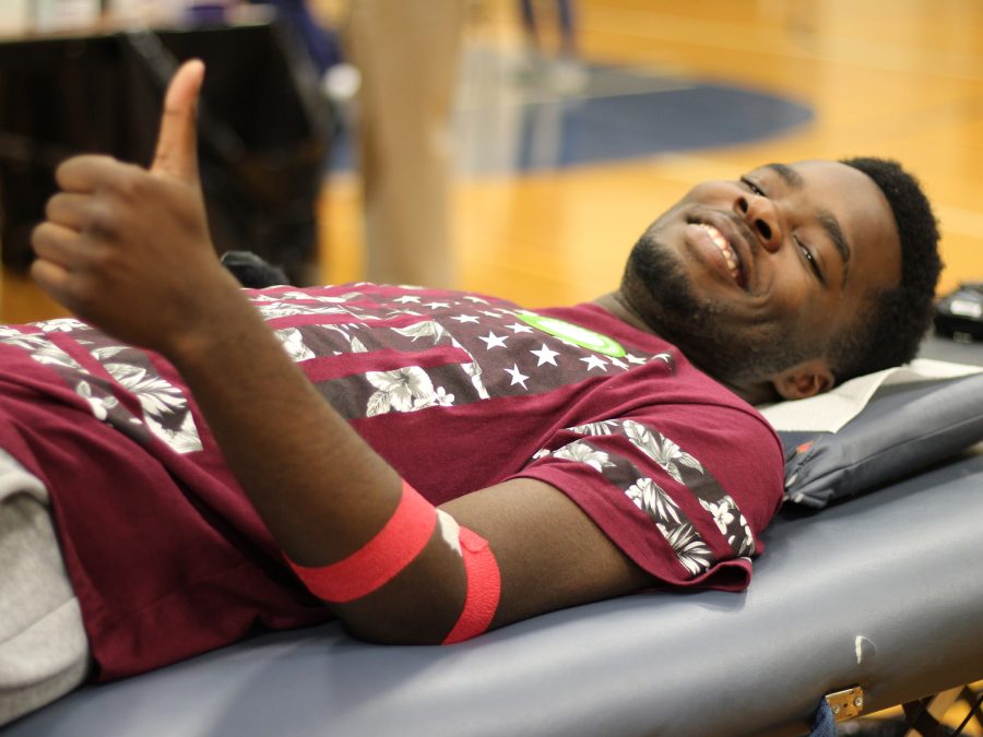 Junior Myron Sykes stayed optimistic even though he wasnt able to donate a full pint of blood. The nurses couldnt properly place the needle in one of his arms so they had to take blood from the other arm. Photo Credit / Jonathan Lo