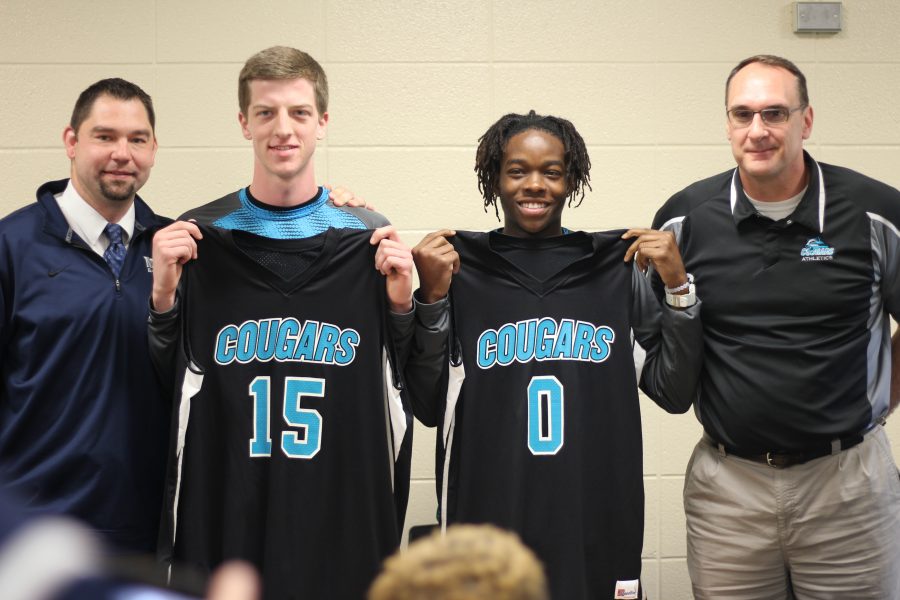 Senior basketball players Grant Mitchell and GK Wells-Lindsay pose with their high school and future college coaches. Both players have played three years of varsity basketball. Photo Credit / Paul Vallier