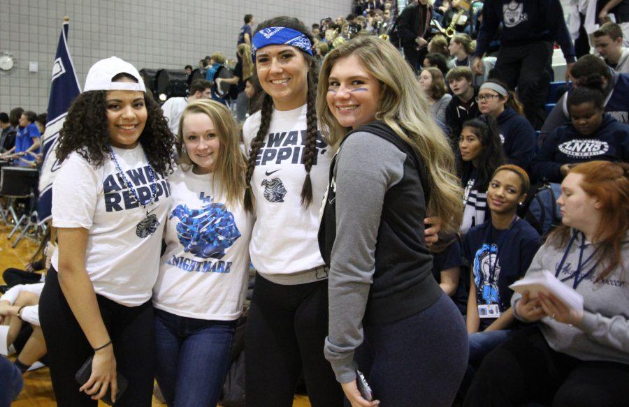Seniors Brittany Day, Julia Townley, Hana Lee and Claudia Ely show ultimate school spirit at the pep assembly on Friday. Blue and white day is a classic end to every spirit week at Loy Norrix High School. Photo Credit / Michaela Whalen