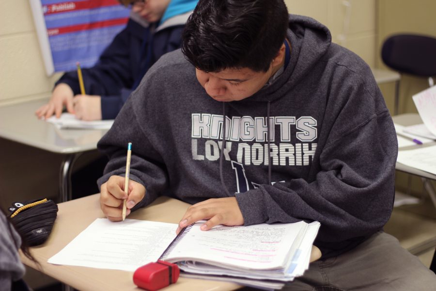 Senior Giovani Diaz studies for final exams in teacher Rebecca Laytons class. Diaz looks over his notes and focuses so that he can do good on exams. Photo Credit / Meghan Lewis