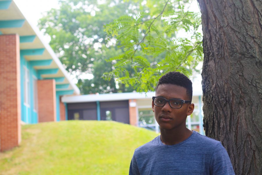 Malik Farrakhan posing in front of Loy Norrix High School. Photo Credit / Henry Snapp