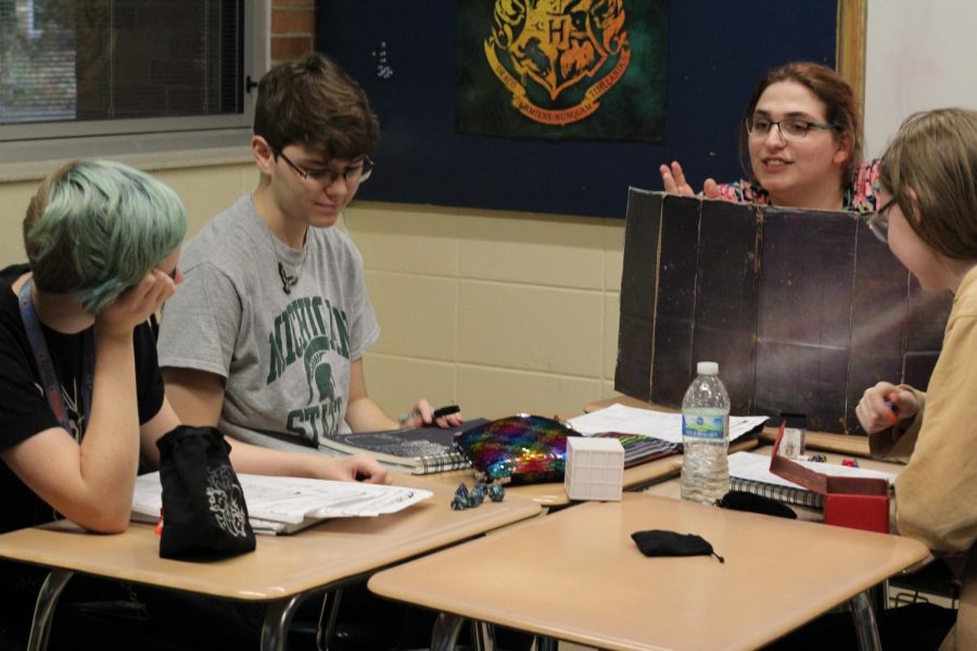 SWORD members Kai Neve-Jones, Asher Gilbert, and Dash DeGrote listen carefully as Dungeon Master Natalie Sweet paints the scene. 
(Left to right: Kai Neve-Jones, Asher Gilbert, Natalie Sweet, and Dash Degrote) 
