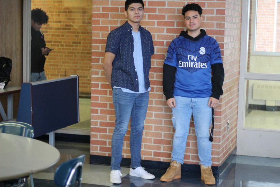 Seniors Carlos Santos and Alan Adunas show off their clothes in the cafeteria. Many students try to dress well to impress their peers.