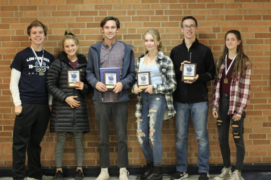 From left to right, junior Keegan Hughes, seniors Ella Schnell and Jozef Meyers, sophomores Lillian Daniels and Gavin Rozanc, and junior Kinsey Skjold pose for a photo after receiving their awards at the cross country awards ceremony. Hughes and Skjold received the sportsmanship award, Meyers and Schnell won the MVP award, and Daniels and Rozanc won the most improved award. Photo Credit / Colin Carnell