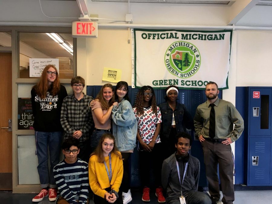 LNHS Green School Club members gather in front of Green School flag after meeting. Green Club meets every Thursday to discuss environmental issues and maintain a green school.