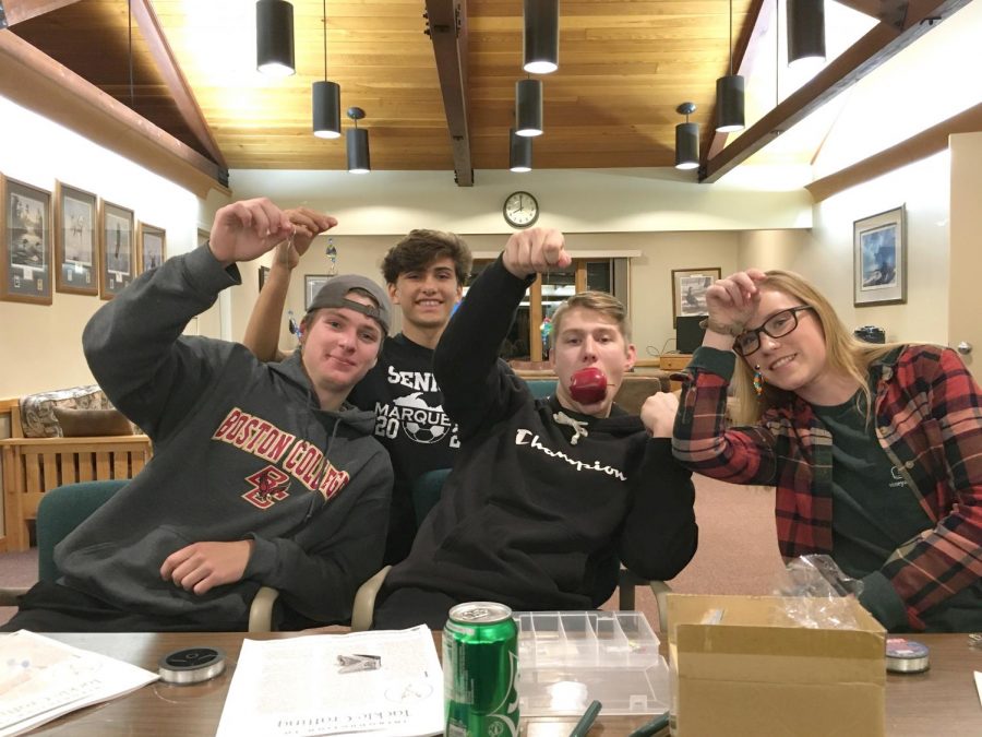 Left to right: Maxwell Spitler, Eli Wiitala, Tanner Peterson, and Maggie Staub hold up fishing lures made during the second day of the meeting. The entire meeting lasts three days and covers multiple topics. 