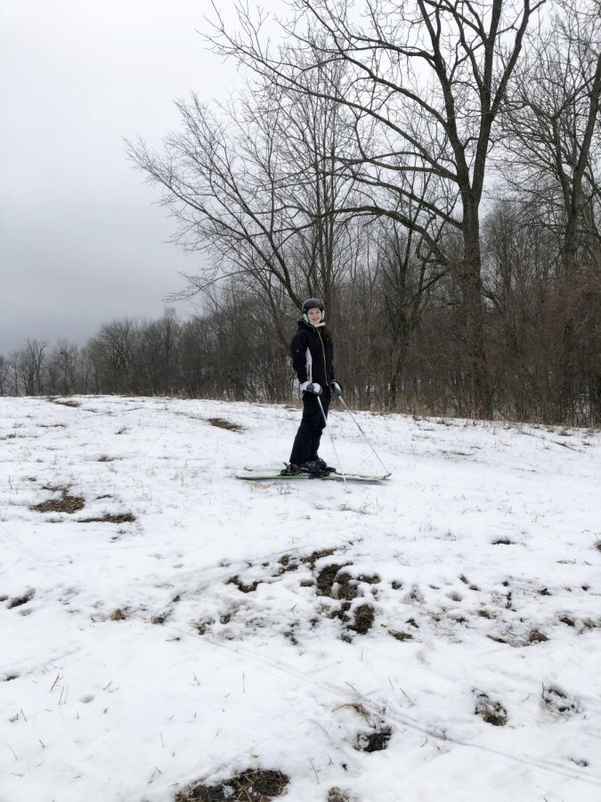 Freshman Lucy Heystek poses on top of the back quad hill right before she skied down. Lucy is spending the day skiing at Timber Ridge ski park. 
