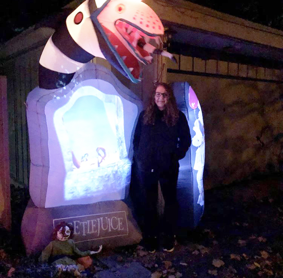 Loy Norrix senior Katie Kutzko stands in front of one of several Halloween decorations that were placed throughout her yard to create a fun and spooky atmosphere, as she and her family handed out candy.