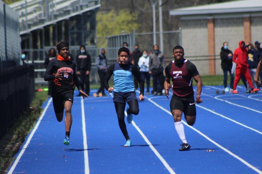 Senior Johnny White competes in the 100 meter yard dash at the Don Lukens Invitational track meet. White places first in this event against Kalamazoo Central and Benton Harbor. 