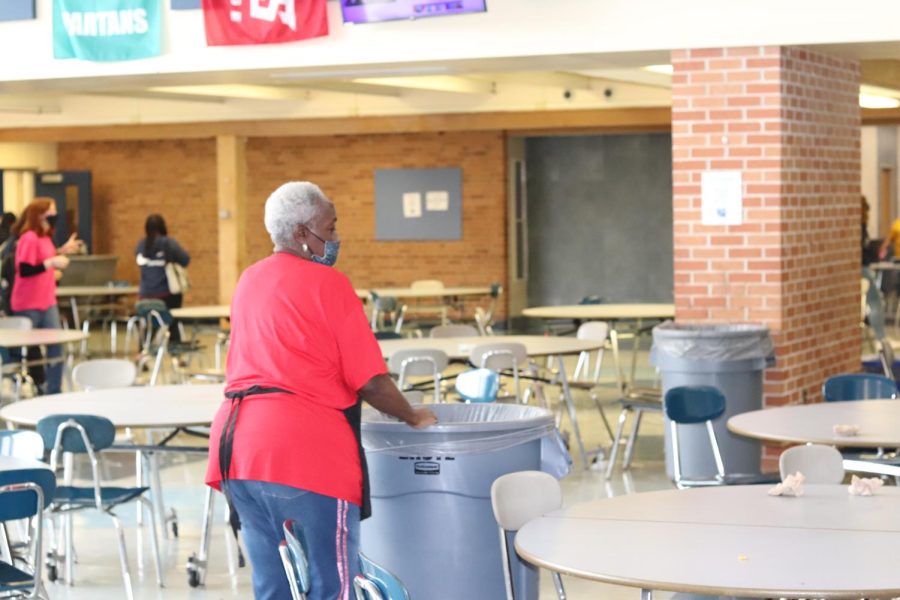 Staff member Arlina Wheaton cleans up in the cafeteria after a lunch period. Wheaton and other lunch staff collect litter left by students in between periods. 