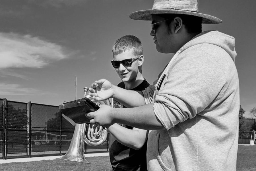 Student Leader Luis Sanchez is helping a student figure out what they need to do in order to succeed in band class. They are actively working on a new set of drills for Senior Night.