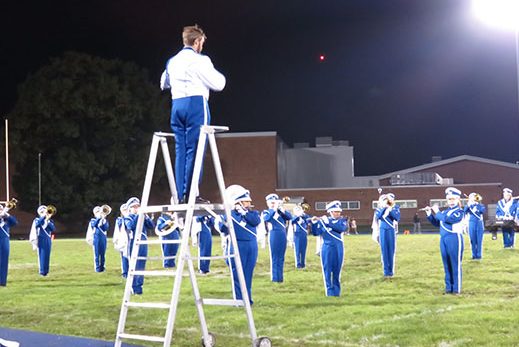 Senior drum major Matthew Gray conducts the band as they play their halftime show finale, “High Hopes” by Panic! At The Disco at the homecoming game on October 15.
