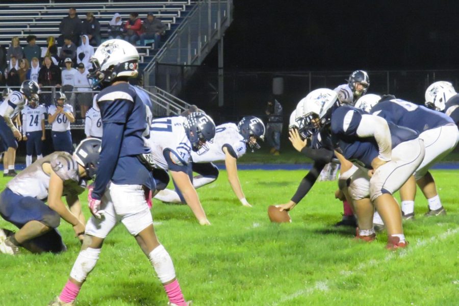 Loy Norrix varisty football team prepares for a play on the offense. The homecoming football game did not end in a win but the team gave it their all. 