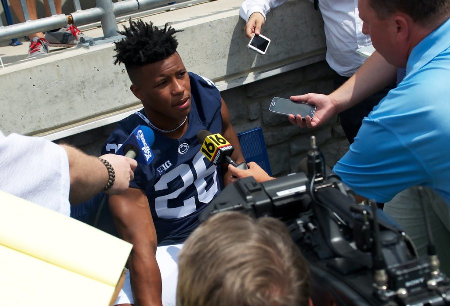 Former Penn State football player Saquon Barkley is interviewed by multiple reporters at Penn State’s Media Day in 2016. Barkley is now a NFL running back for the New York Giants.