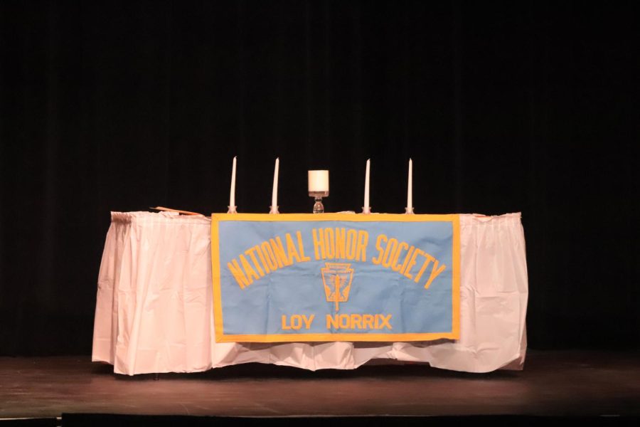 The Nation Honor Society table of virtue being set up before the symbolic candles are lit. Each candle represents the pillars of NHS, character, service, scholarship and leadership. 