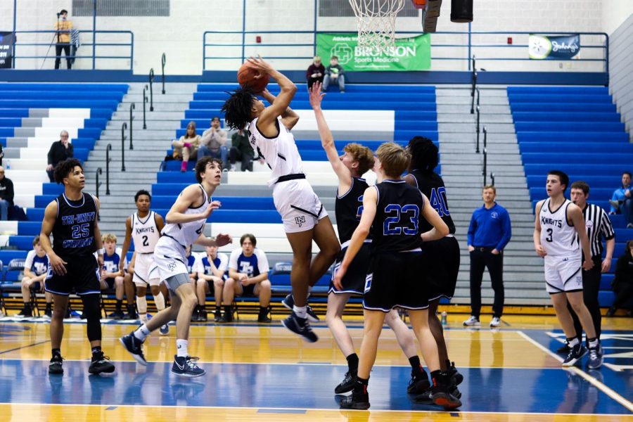 Senior Kevin Lucas goes up for a layup against multiple Tri-Unity players. 