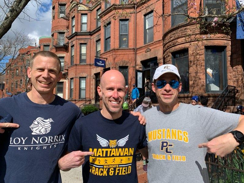 (From left to right) Loy Norrix Coach Bradley Schmidt, Matawan Coach Scott VanLoo, and Portage Central coach Noah Krzan sporting their respective school gear before the race.