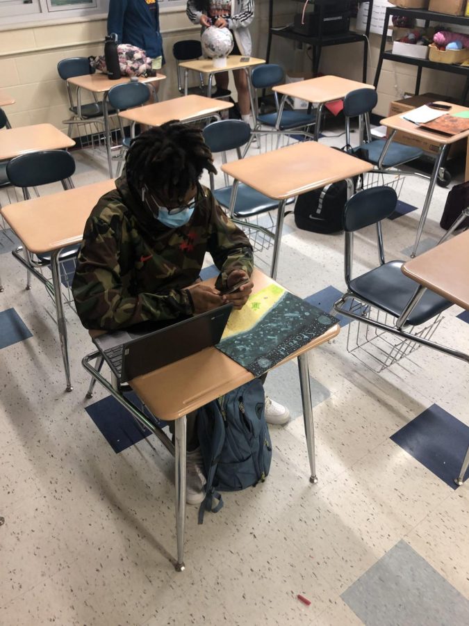 Loy Norrix student checks their phone in class. Students and teachers alike have noticed the affect of the pandemic on this particular habit.