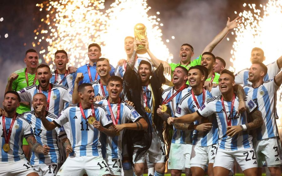 Argentinas captain Lionel Messi lifts the World Cup trophy after beating France on Penalties to be crowned world champions