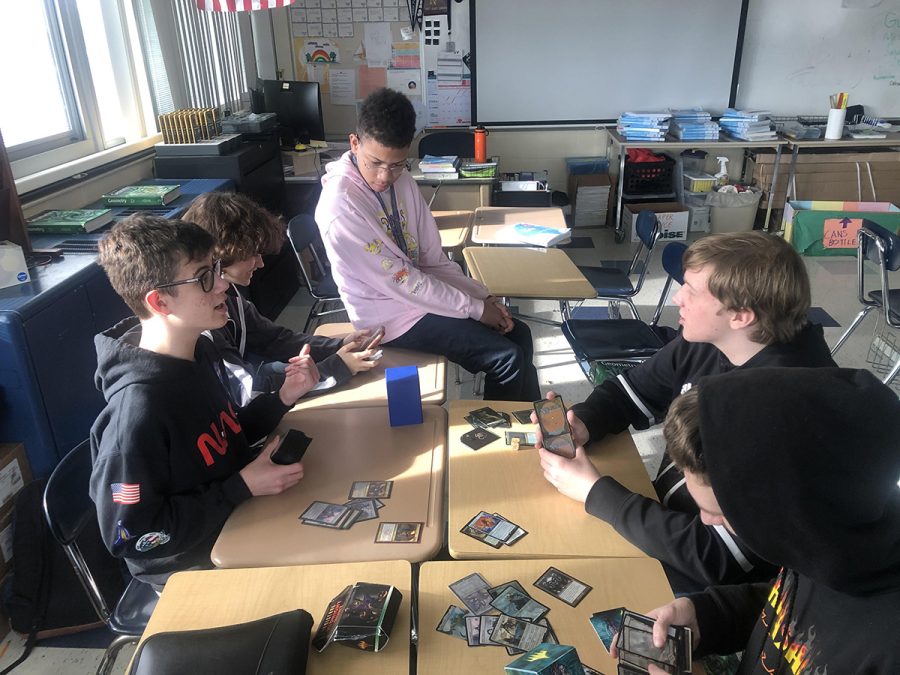 Liam Crookston does battle with other students at Sword and Board. The game they are playing is Magic: The Gathering