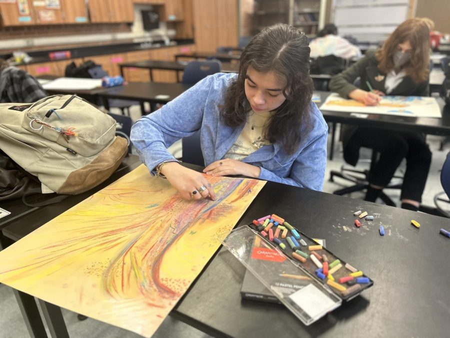 Isabella Figueroa working on her project for advanced art for portfolio prep class. With two days left before its due, Isabella adds finishing touches.