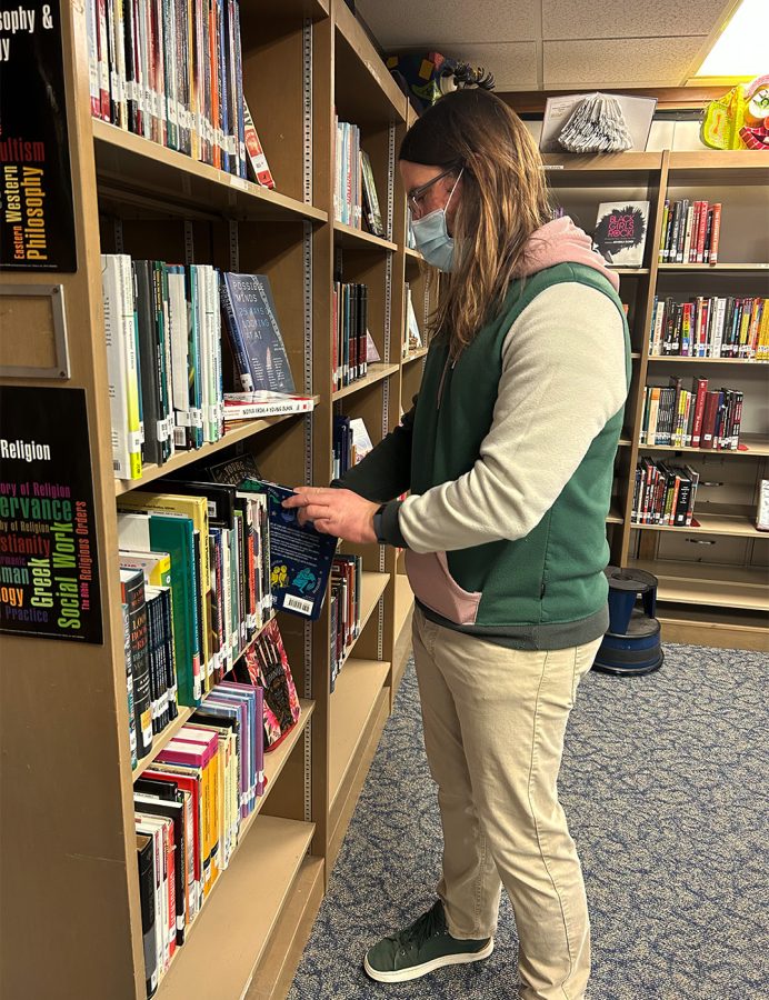 Librarian John Krieder re-shelves books after they are returned. This is part of Krieders tasks as the Norrix librarian. 