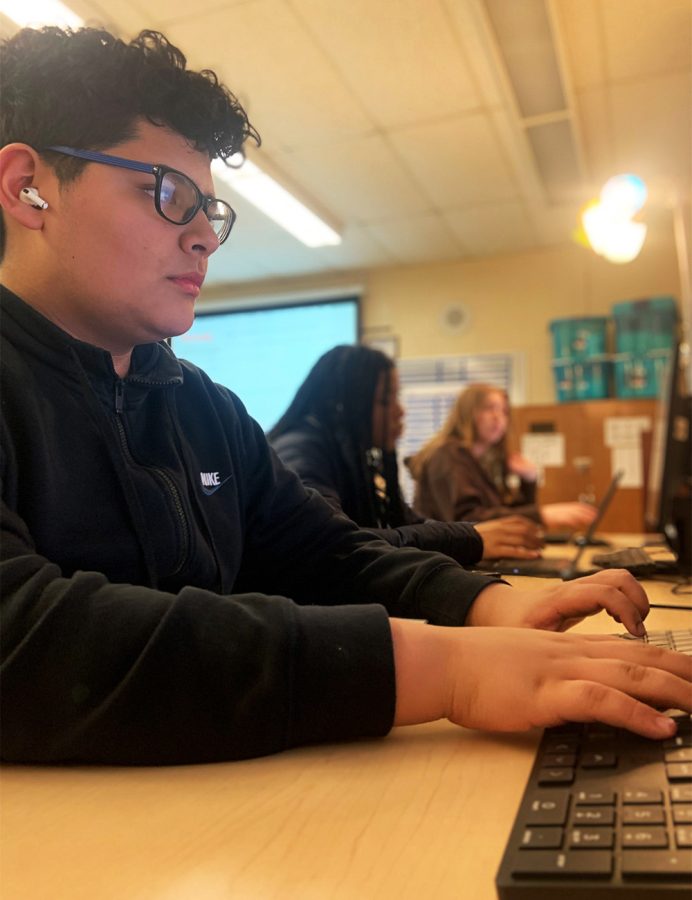 Freshman Juan Ortiz-Ponce listens to music while he types his story. He is so heavily focused and engaged on his work. He finds that when he listens to Spanish music it helps him focus. 