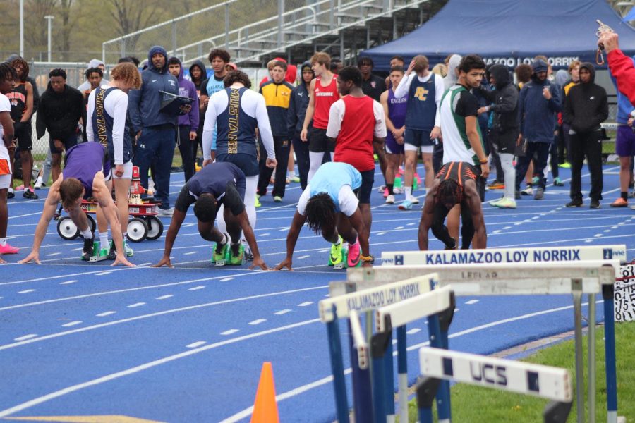 Sprinters+prepare+to+begin+their+event+on+the+starting+line+of+the+Loy+Norrix+track.+