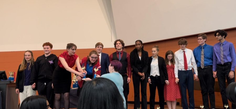 Forensics team members accept their trophy at the MIPA conference. Many team members attribute their success to the amount of preparation done prior to the events.