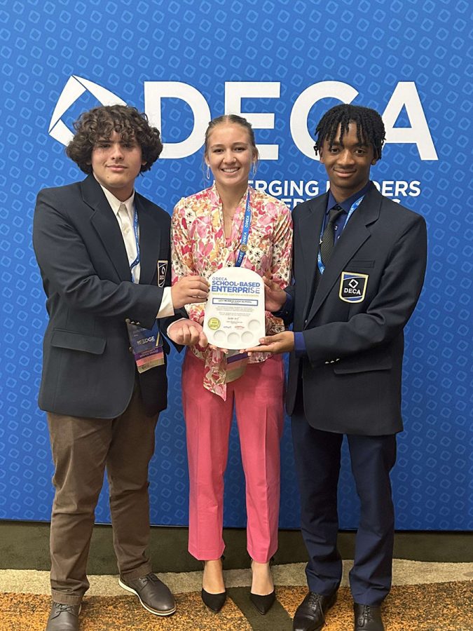 Max Berlin (Left), Wendy Miedema (Middle) and Ari Johnson (Right) stand together with their award at DECA districts. This victory led them to DECA nationals. 