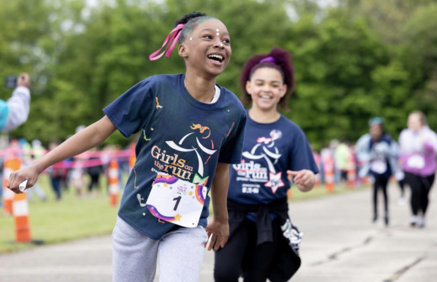 London Lee (left) and Aluara Osborn (right) running the celebratory 5K with smiles on their faces. The Girls on the Run 5K was at Kalamazoo Valley Community College. 