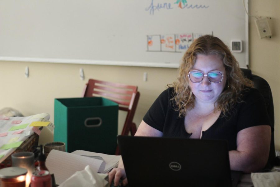 Rebecca Layton works at her desk on end of the year work. In her classes a research project, called the Capstone, takes the place of a final exam.

