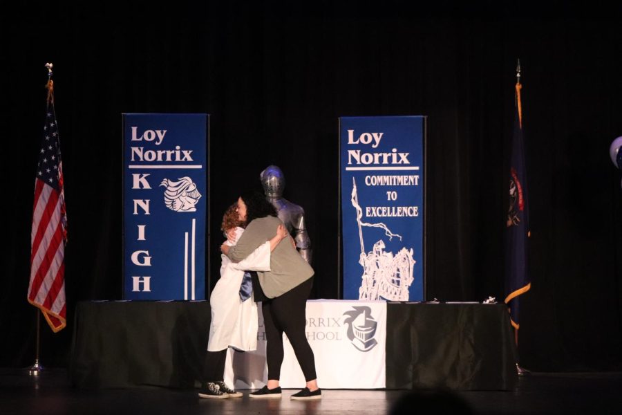 Senior Jillian Dantes embraces Norrix Counselor Department Head Becky Parsons. Many members in the audience were moved by this heartfelt moment. 