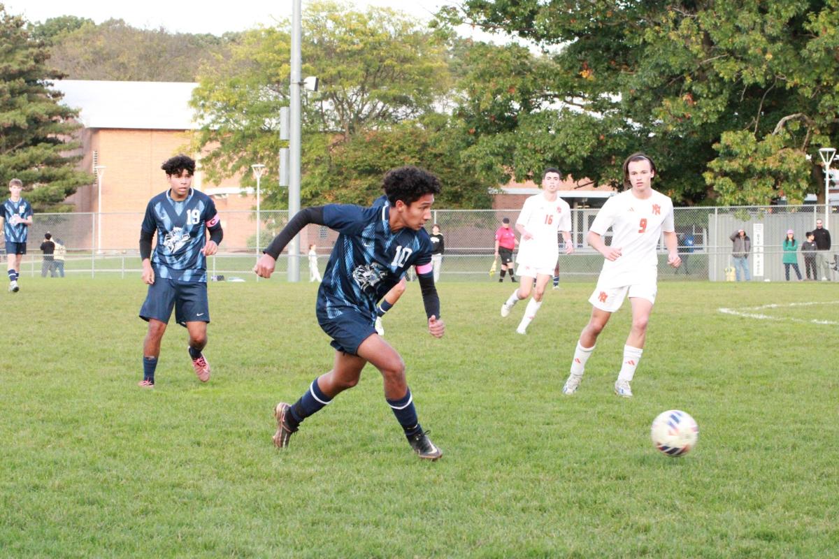 Junior Mario Aseburey defending the ball while dribbling down the field. The Knights soccer team later went on to win the game defeating the Portage Northern Huskies 2-1. 
