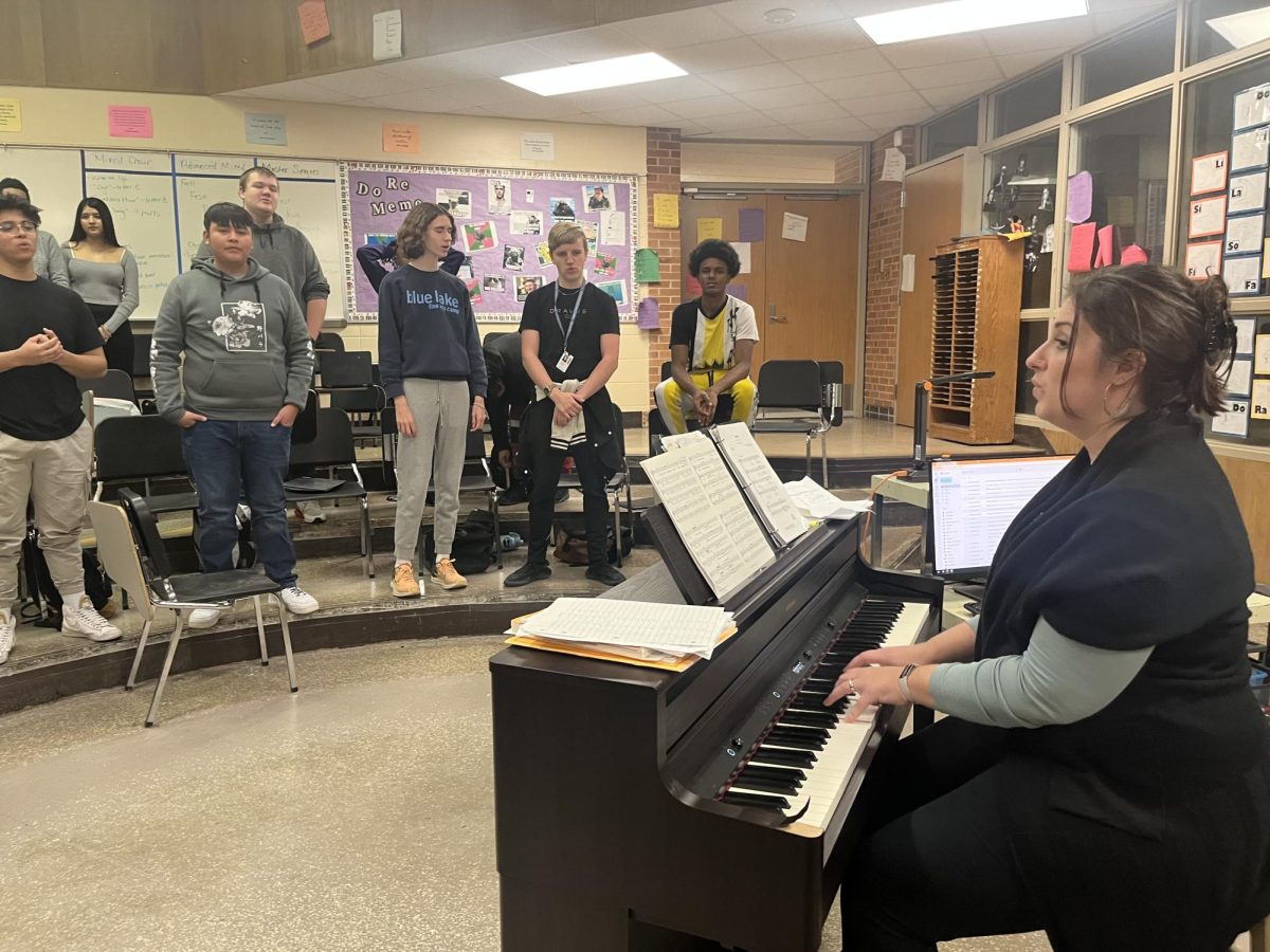 Loy Norrix mixed choir students warming up to Banaha. Choir teacher Marisa Bergh is getting her students ready to rehearse Oye by Jim Papoulis.