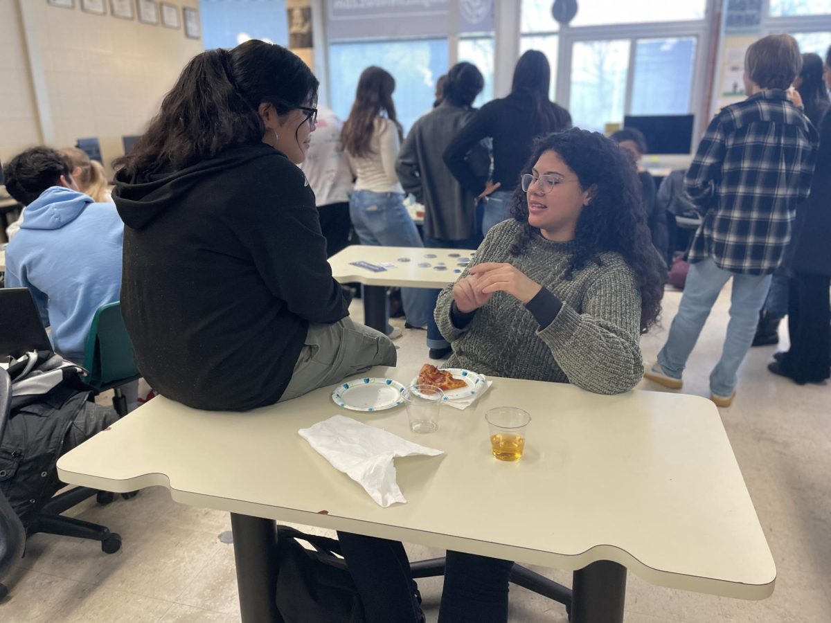 Youth Ambassador Gabriella Pinheiro Gonçalves and Loy Norrix student Venelope Ortiz bond over lunch. This was an opportunity for students to learn about different cultures and connect with one another.