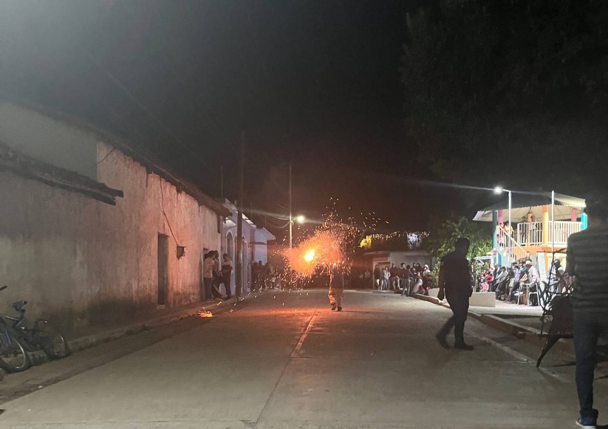 Yetla de Juárez preparing for the celebration of the upcoming new year 2024. The lively street of Pdte Juárez is filled with people watching the first bull of the night.
