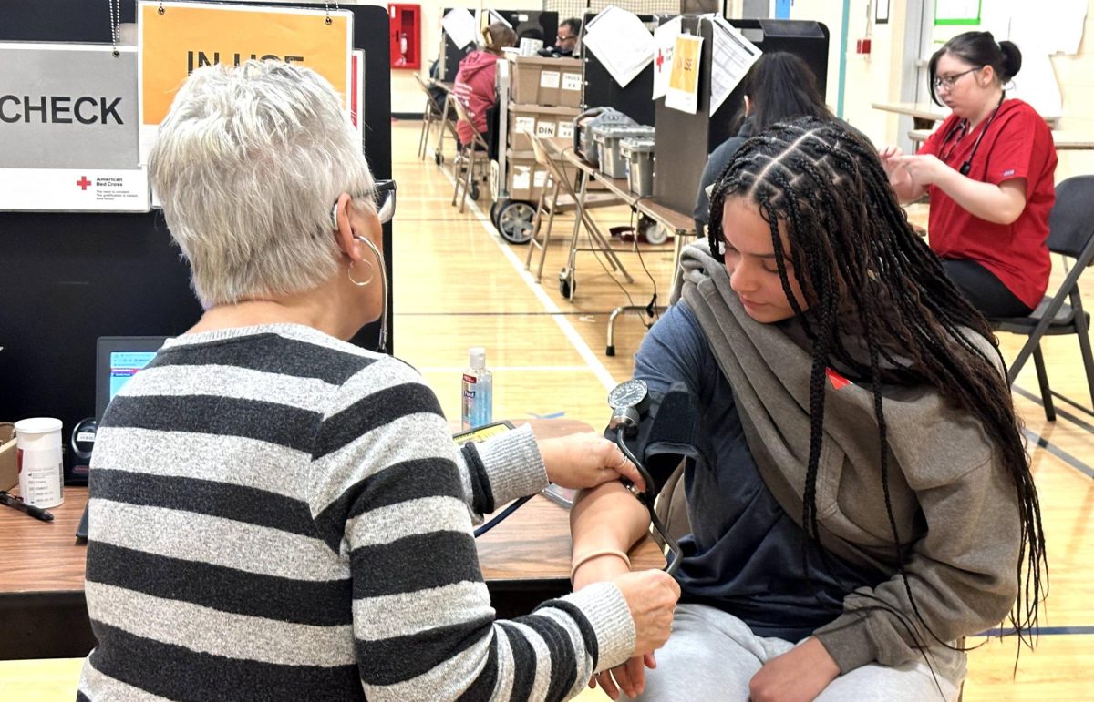 Red Cross Supervisor Cindy Vandermeer prepares Teya Dawson for her blood donation. Dawson was a first-time donor. 
