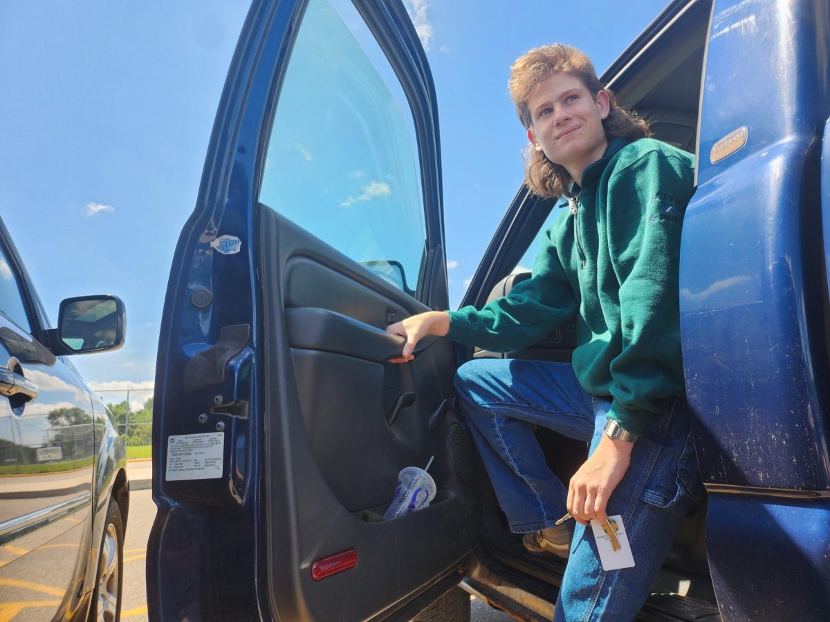 Photo Illustration. Junior Dimitri Agdanowski steps out of his truck, ID in hand, ready for the day ahead. He looks out to the blue sky, not knowing what the day has for him, but prepared to conquer the day.