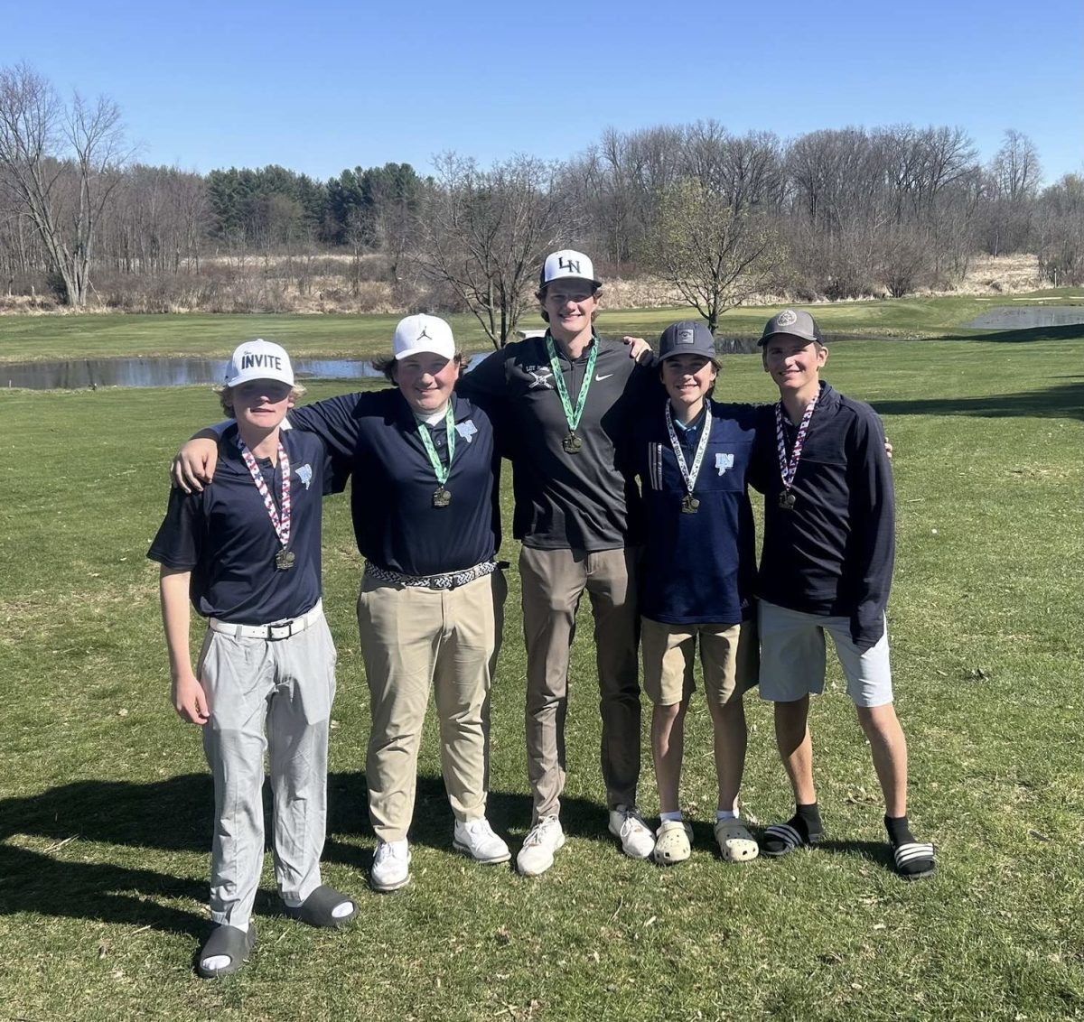 Members+of+the+golf+team%2C+%28from+left+to+right%29+Samuel+Gagie%2C+Xander+Gorham%2C+Isaac+Scarvarda%2C+Griffin+Moore+and+Aaron+Teal%2C+stand+arm+in+arm+after+a+tough+victory+in+one+of+their+tournaments.+They+all+played+their+hardest+and+are+happy+to+earn+this+win.+