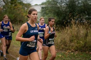 Junior runner Amelia Murphy stays ahead of a pack of runners during her race at the Otsego Bulldog Invitational. Murphy finishes the race with a season's best time of 34:16.