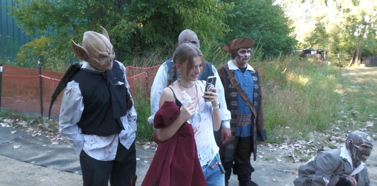 Scream actors circle journalist Rosie Hill as she films a video. When she turned around they all scared her.