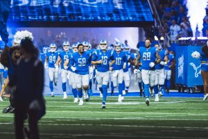 The crowd goes wild as the Detroit Lions run out on their home field. 